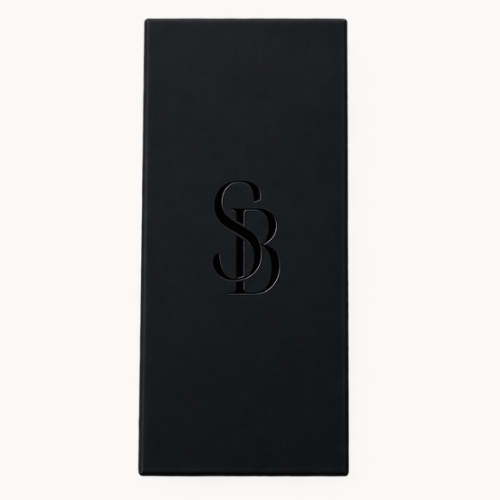 A tall, black rectangular matchbox with Saltbush Living debossed interlocking &